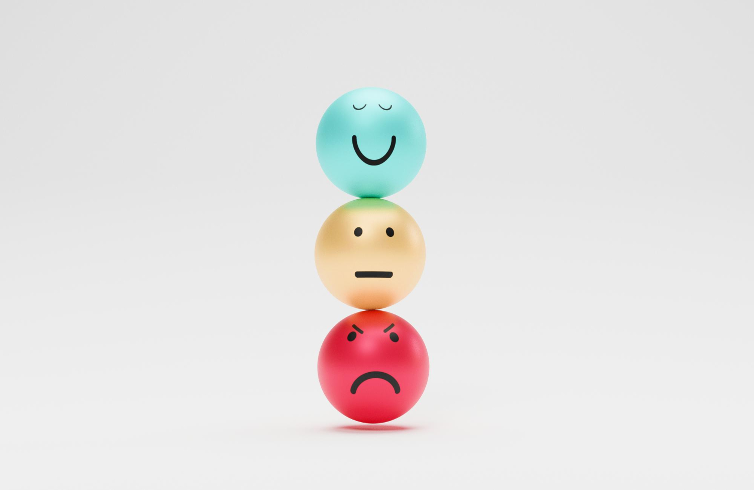 74 Three balls stacked vertically with happy, neutral, and angry faces from top to bottom on a white background.